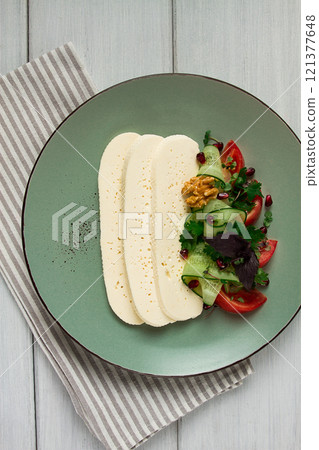 Sliced Imeruli cheese, Georgian cheese, with vegetables, top view, no people, 121377648