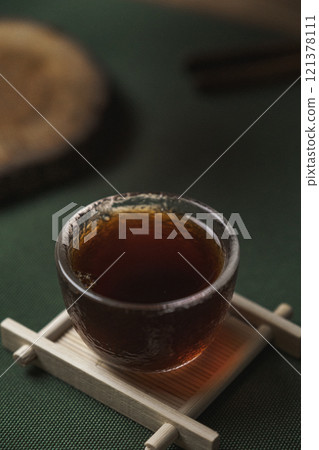 Inviting a Cup of Delightfully Aromatic Tea Presented on a Tranquil Surface or Tabletop Inviting a Cup of Delightfully Aromatic Tea Presented on a Tranquil Surface or Tabletop 121378111