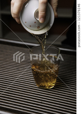 Pouring Tea into a Glass A Traditional Asian Ceremonial Practice Invoking Serenity 121378146