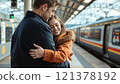 The girl met her boyfriend at the train station, a happy, long-awaited meeting. Hugs him. 121378192