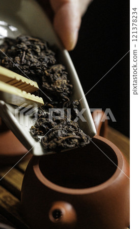 Engaging in the Tea Brewing Ritual using highquality Loose Leaf Tea and a traditional Teapot Engaging in the Tea Brewing Ritual using highquality Loose Leaf Tea and a traditional Teapot 121378234