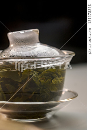 Experience Beautifully Brewed Tea Leaves Presented in an Elegant Transparent Teapot 121378238