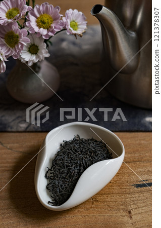 An Elegant Tea Setup Featuring Loose Tea Leaves Beautifully Arranged with Fresh Flowers An Elegant Tea Setup Featuring Loose Tea Leaves Beautifully Arranged with Fresh Flowers 121378307