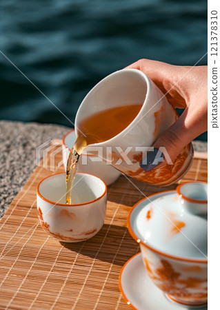 An Elegant Tea Ceremony conducted beautifully by the Water, creating a special moment 121378310