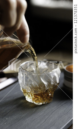 Pouring a fine whiskey into a beautifully textured glass is a true art form of enjoyment 121378351