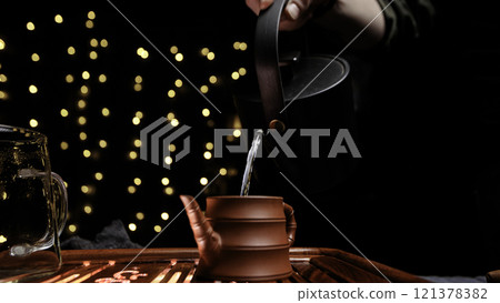 Experience the Elegant Pouring of Tea in Soft Dim Lights with a Beautiful Decorative Pot Experience the Elegant Pouring of Tea in Soft Dim Lights with a Beautiful Decorative Pot 121378382