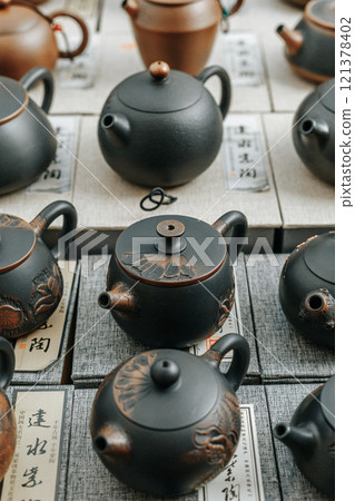 A Beautiful Display of Traditional Teapots in a Stunning and Artistic Arrangement 121378402