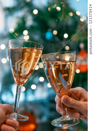 A Vibrant Celebratory Toast Featuring Sparkling Drinks and Beautiful Holiday Lights 121378414