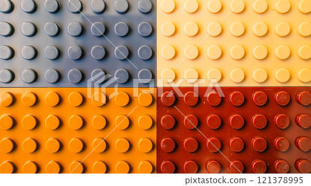 Colorful building blocks macro background texture in grey, yellow, orange and red colors 121378995