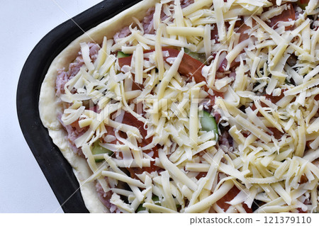 Cooking meat pizza. Pizza toppings before frying. 121379110