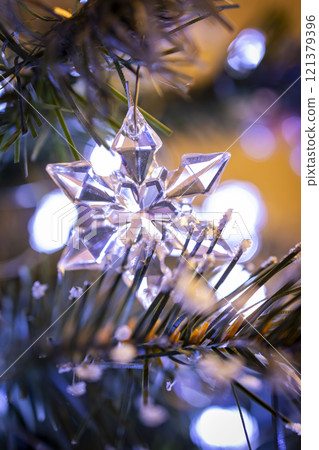 A simple and elegant Christmas tree decorated with white lights and a few delicate ornaments. Perfect for creating a minimalist and modern holiday atmosphere. 121379396