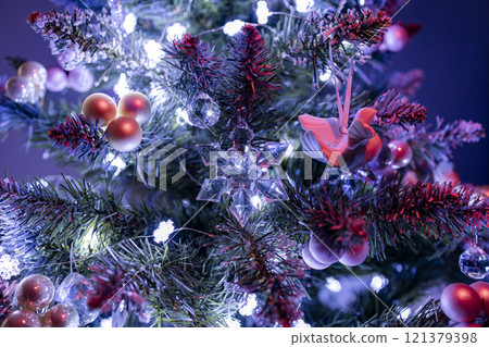 A simple and elegant Christmas tree decorated with white lights and a few delicate ornaments. Perfect for creating a minimalist and modern holiday atmosphere. A simple and elegant Christmas tree decorated with white lights and a few delicate ornaments. Perfect for creating a minimalist and modern holiday atmosphere. 121379398