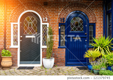 View of beautiful front doors of two neighbouring Dutch Netherlands town houses on a Dutch Street Amsterdam. View of beautiful front doors of two neighbouring Dutch Netherlands town houses on a Dutch Street Amsterdam. 121379745
