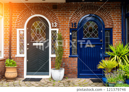View of beautiful front doors of two neighbouring Dutch Netherlands town houses on a Dutch Street Amsterdam. 121379746