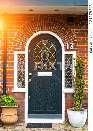 typical century Dutch door holland view in a fortified town with brick houses and front flower gardens. Typical dutch door 121379748