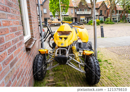 Yellow quadbike at the city street. Yellow quadbike at the city street. 121379810