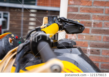 Yellow quadbike at the city street. Yellow quadbike at the city street. 121379813