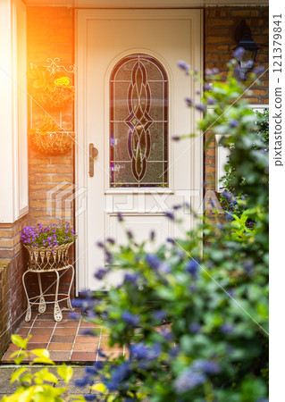 Facade of typical Dutch door house with brick walls, steps, front door windows. Doors on the street, Netherlands 121379841