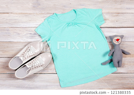 T-shirt mockup on wooden background. Perfect for displaying t-shirt designs. T-shirt mockup on wooden background. Perfect for displaying t-shirt designs. 121380335