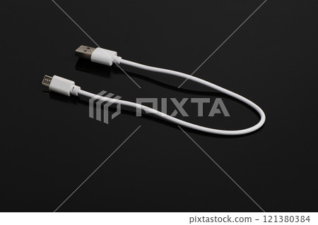 USB cable on a black background. USB cable on a black background. 121380384