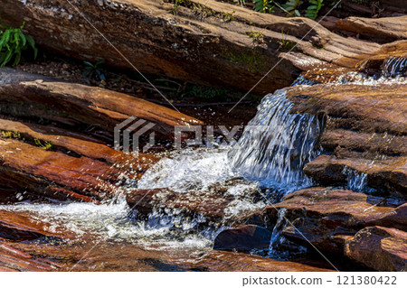 Water flowing over the rocks 121380422