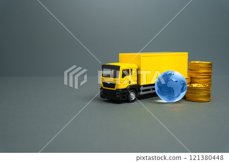 Yellow truck with globe and money coins. International transportation of goods and cargo. Transport logistics companies. Economic relations. Trade. 121380448