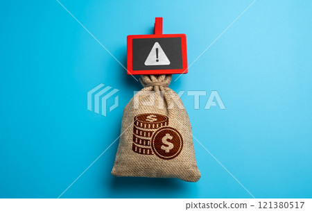 Money bag and warning sign. Emergency funds. The problem of legality and legitimate origin. Freezing and confiscation of financial resources. Money bag and warning sign. Emergency funds. The problem of legality and legitimate origin. Freezing and confiscation of financial resources. 121380517