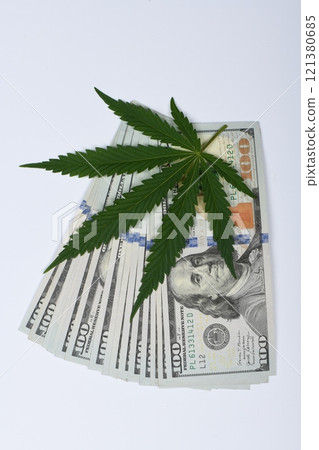 Hemp leaf and dollars on white background, closeup. Hemp leaf and dollars on white background, closeup. 121380685