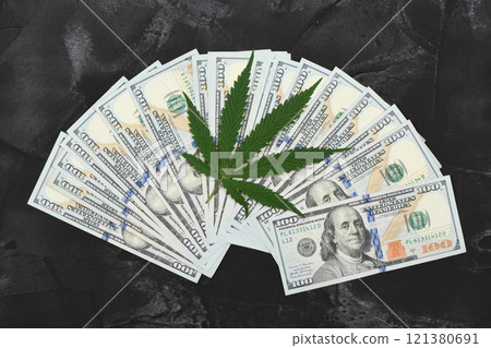 Hemp leaf and dollars on black background, closeup. 121380691