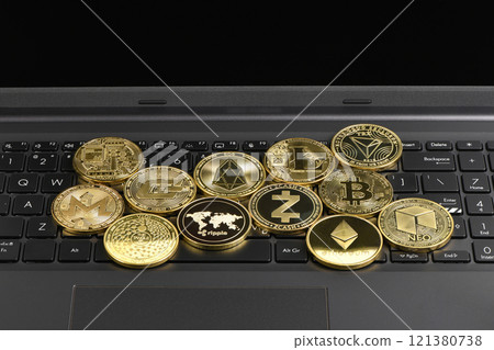 Golden Cryptocurrency on keyboard laptop, Bitcoin , Ethereum, Litecoin, Dashcoin, XRP, EOS, NEO, TRX, Monero, Zcach, Iota and Ripple coins. Golden Cryptocurrency on keyboard laptop, Bitcoin , Ethereum, Litecoin, Dashcoin, XRP, EOS, NEO, TRX, Monero, Zcach, Iota and Ripple coins. 121380738