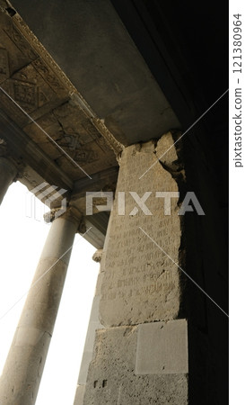 Ancient and historical ruins featuring grand pillars adorned with intricate inscriptions Ancient and historical ruins featuring grand pillars adorned with intricate inscriptions 121380964
