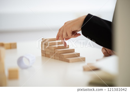 Businesswoman walking her fingers up the conceptual steps Businesswoman walking her fingers up the conceptual steps 121381042