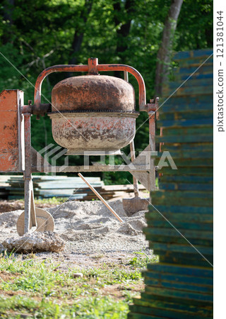 Cement mixer standing in construction site 121381044