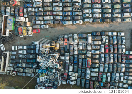 Aerial view of big parking lot of junkyard with rows of discarded broken cars. Recycling of old vehicles Aerial view of big parking lot of junkyard with rows of discarded broken cars. Recycling of old vehicles 121381094