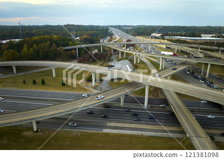 Aerial view of american freeway intersection with fast moving cars and trucks. USA transportation infrastructure concept 121381098