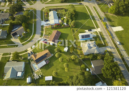 Aerial landscape view of suburban private houses between green palm trees in Florida quiet rural area 121381120