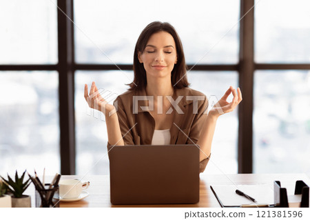 Mental Hygiene. Calm beautiful girl meditating at workplace, dealing with stress and anxiety. Empty space 121381596