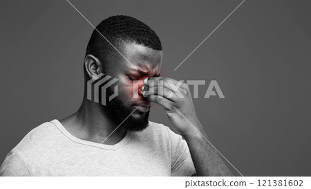 Tired afro man touching his nose bridge, suffering from eye pain, tired eyes, copy space Tired afro man touching his nose bridge, suffering from eye pain, tired eyes, copy space 121381602