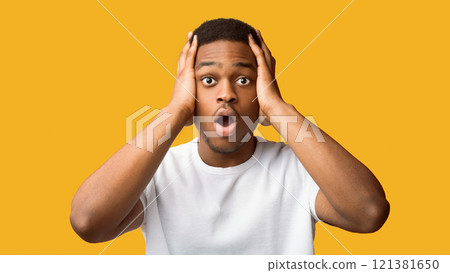Oh No. Scared black guy clasping his head with open mouth isolated over orange studio wall, copyspace, panorama 121381650