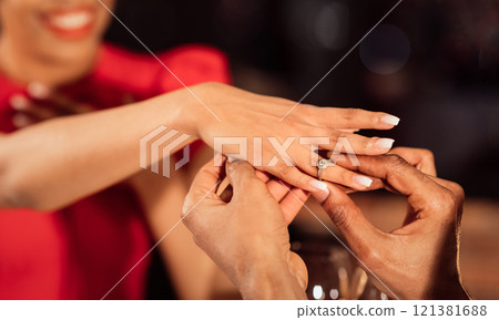 She Said Yes. Unrecognizable Boyfriend Putting Engagement Ring On Girlfriend's Hand Proposing During Romantic Date In Fancy Restaurant. Panorama, Cropped 121381688