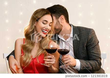 Valentine's Dinner. Man Whispering Love Words To His Happy Girlfriend On Romantic Date In Restaurant Valentine's Dinner. Man Whispering Love Words To His Happy Girlfriend On Romantic Date In Restaurant 121381819