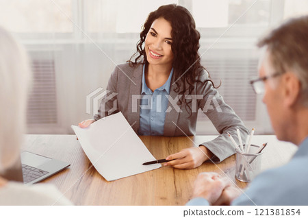 Best Travel Offer. Young female mexican travel agent consultant signing documents with mature customers in tour agency Best Travel Offer. Young female mexican travel agent consultant signing documents with mature customers in tour agency 121381854