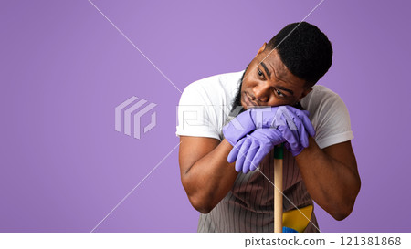 Exhausted Black Guy Leaning On Mop Handle, Resting Head On Hands Tired After Cleaning, Standing Over Pink StudioBackground With Free Space Done Exhausted Black Guy Leaning On Mop Handle, Resting Head On Hands Tired After Cleaning, Standing Over Pink StudioBackground With Free Space Done 121381868