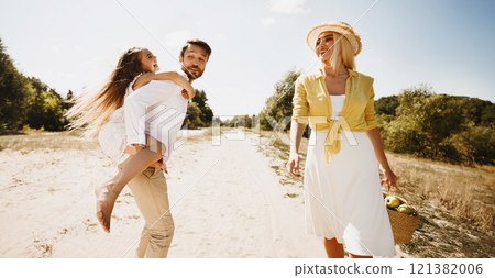 Finally, Outdoor. Family Of Three Walking Outside, Father Carrying Daughter Having Fun On Summer Day In Countryside. Finally, Outdoor. Family Of Three Walking Outside, Father Carrying Daughter Having Fun On Summer Day In Countryside. 121382006