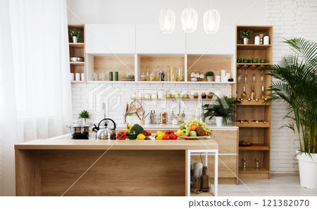 Modern light wooden kitchen with island and big table, free space 121382070