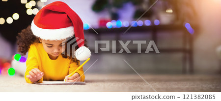 Xmas wishlist. Cute black girl in Santa hat writing presents list for parents on winter holidays, free space Xmas wishlist. Cute black girl in Santa hat writing presents list for parents on winter holidays, free space 121382085