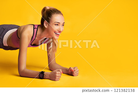 Workout. Fitness Girl Doing Plank Exercise And Smiling Over Pink Studio Background. Free Space 121382138
