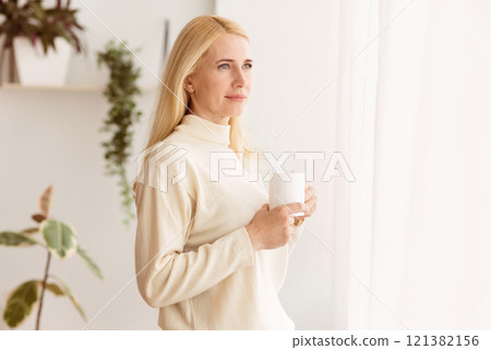 Middle-Aged Woman Drinking Coffee And Looking Through Window, Having Rest At Home 121382156