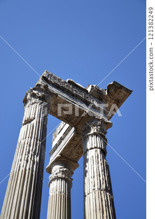 Ionic Columns of the Temple of Saturn in the Forum Romanum, Rome, Italy, clear blue sky sunny day 121382249