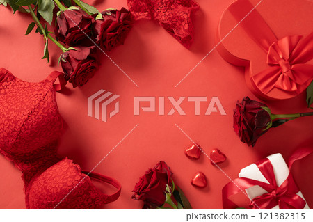 Valentine's day frame with red lace bustier underwear, gifts, candy sweets and red roses on red background. Love. View from above. Copy space. Romantic dating. Valentine's day frame with red lace bustier underwear, gifts, candy sweets and red roses on red background. Love. View from above. Copy space. Romantic dating. 121382315